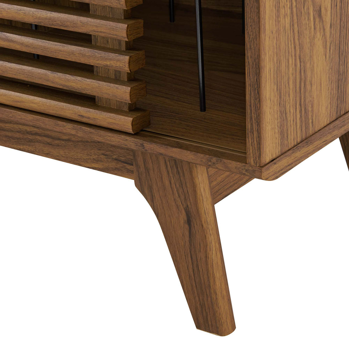 Detail of walnut stand leg showing wood grain texture, angled silhouette, and solid support base. || EEI-4263-WAL || leg_studio