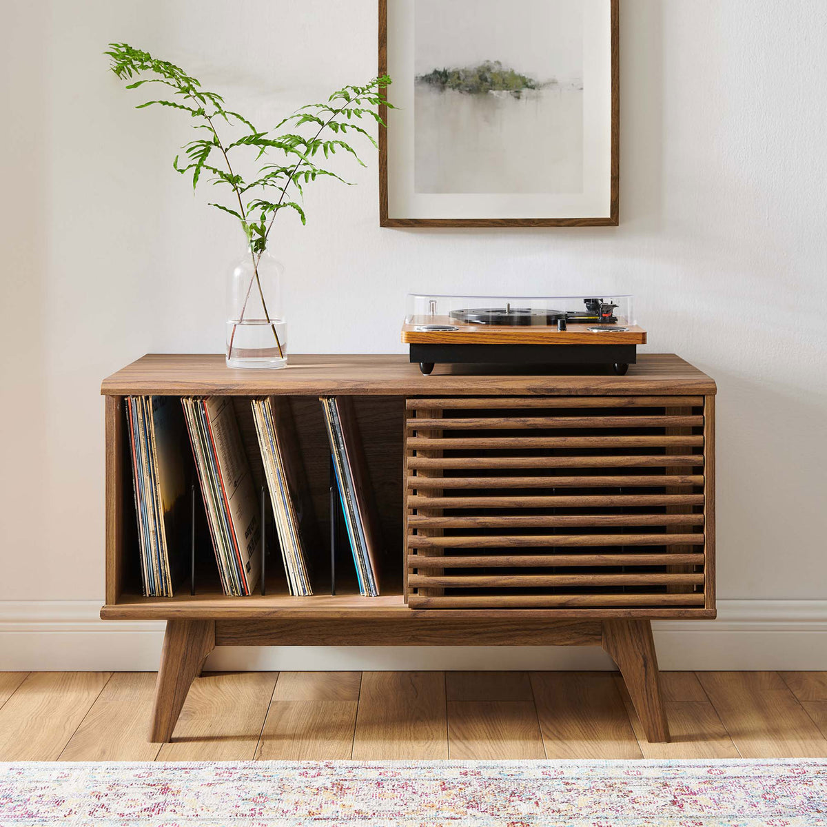 Walnut record stand styled in a cozy living room with albums displayed and turntable ready for play. || EEI-4263-WAL || front_open_room