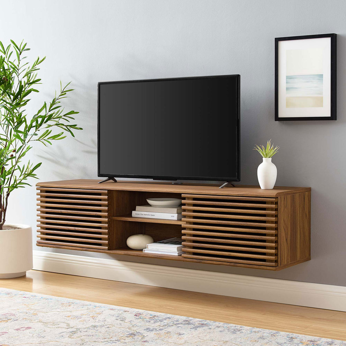 Spacious 60 inch wall-mounted media console styled under a large TV with books and decor accents. || EEI-4267-WAL || front_angle_room