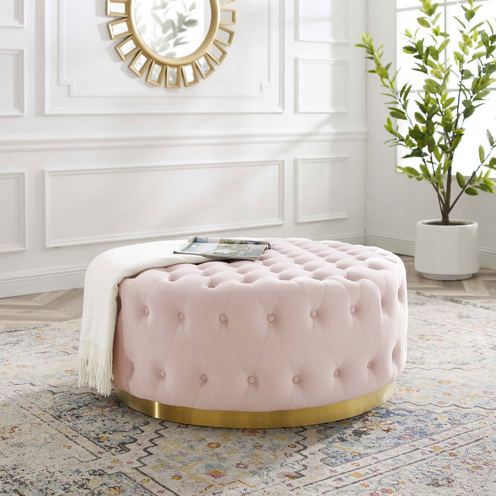 Pink tufted round ottoman with gold base styled in an elegant white living room || EEI-4326-PNK || front_angle_room