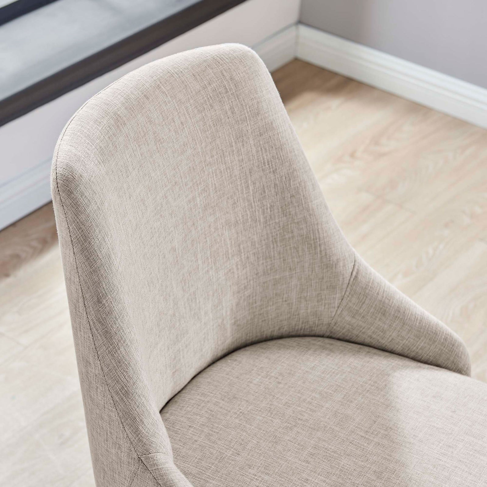 Beige upholstered office chair in a bright workspace showcasing the smooth seat and softly contoured back || EEI-4371-BLK-BEI || detail_room