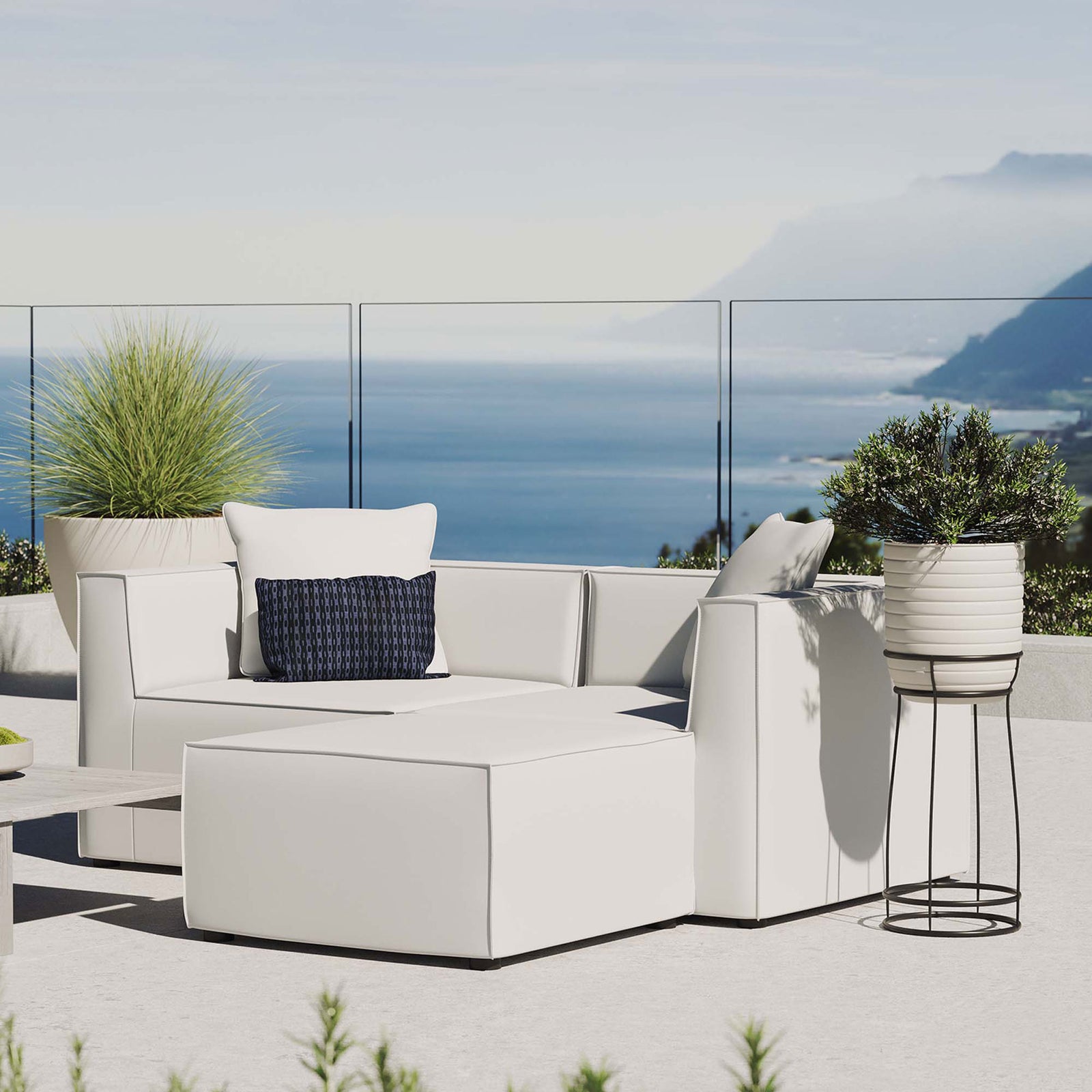 White outdoor loveseat and ottoman arranged on a terrace for bright, breezy coastal lounging || EEI-4378-WHI || front_angle_room