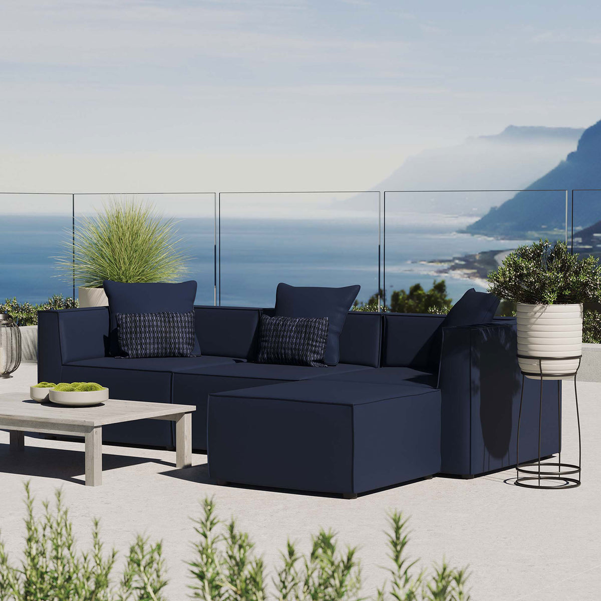 Navy Saybrook sectional arranged on a scenic terrace with accent pillows and greenery || EEI-4380-NAV || front_angle_room