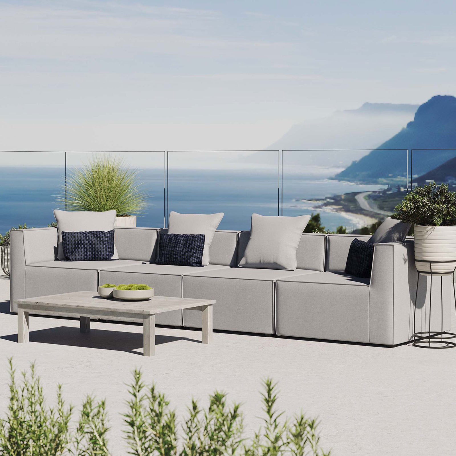 Gray 4-piece outdoor sectional sofa styled on a coastal terrace with soft neutral accent pillows || EEI-4381-GRY || front_angle_room