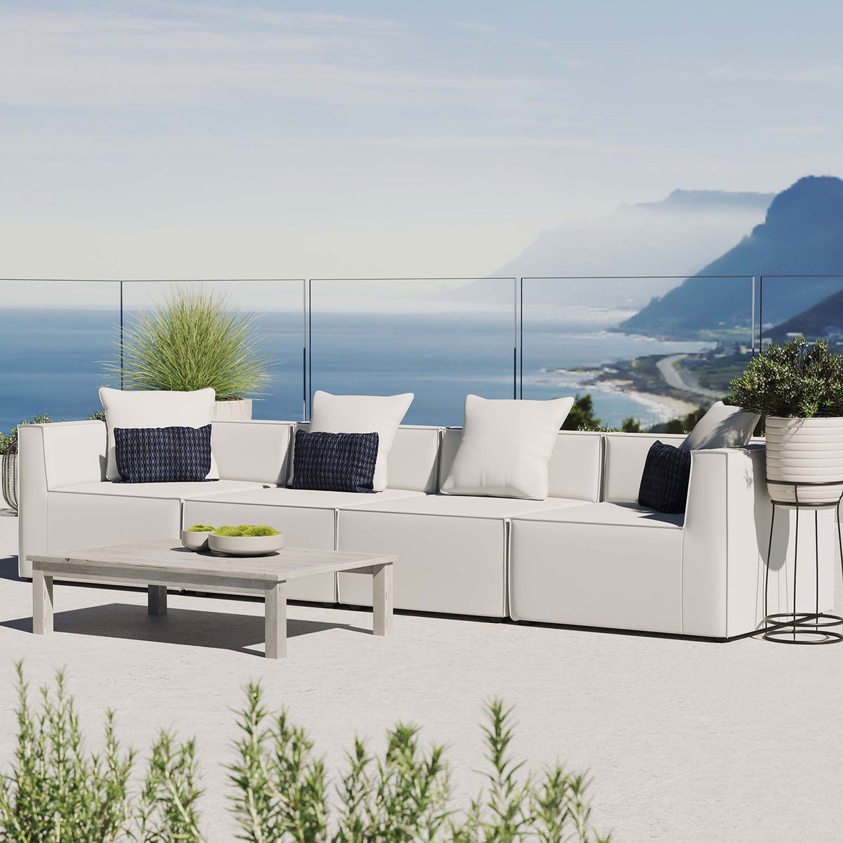 White 4-piece outdoor sectional sofa styled on a sunlit terrace with blue accent pillows || EEI-4381-WHI || front_angle_room