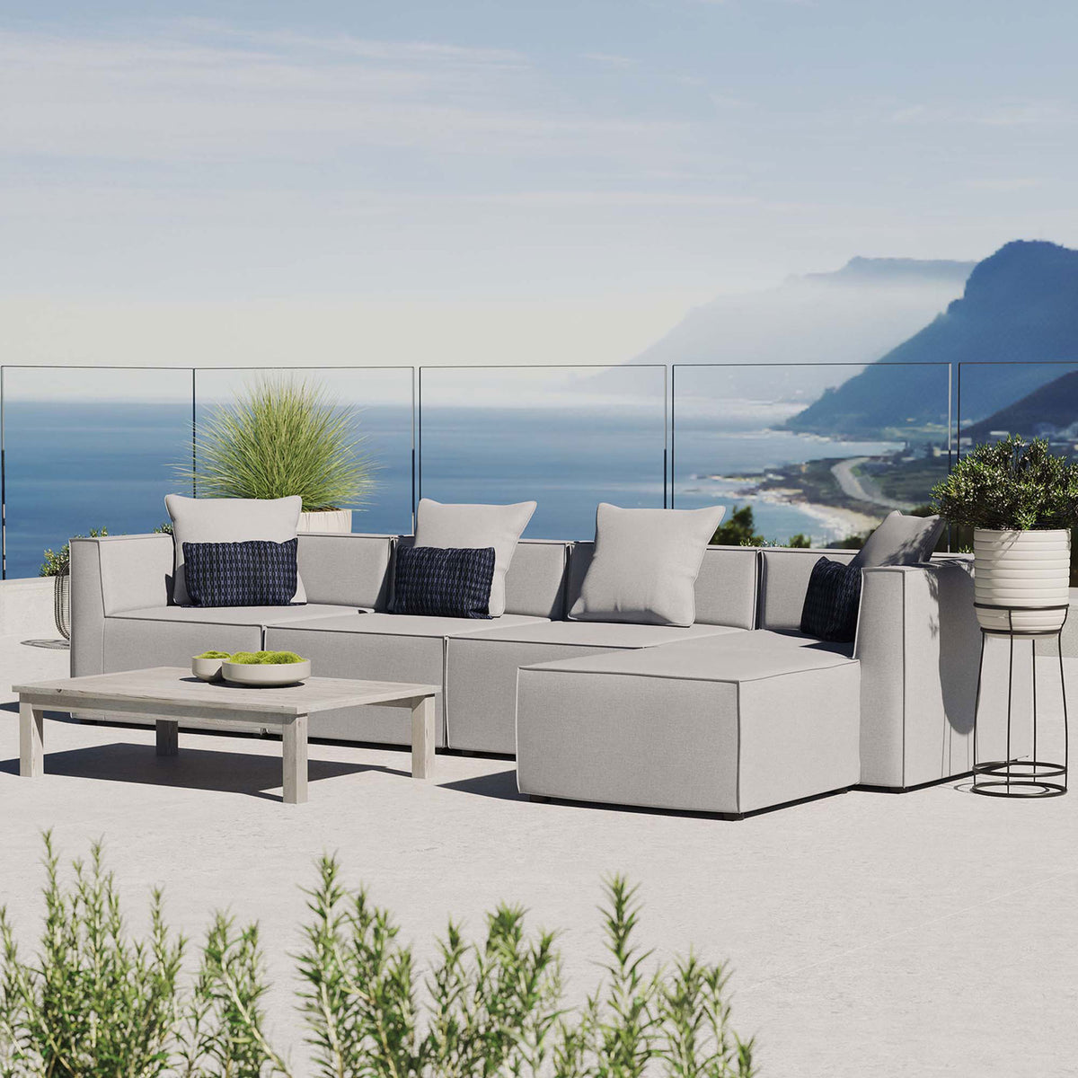 Gray Saybrook outdoor sectional arranged on a coastal terrace with modern accent decor || EEI-4382-GRY || front_angle_room