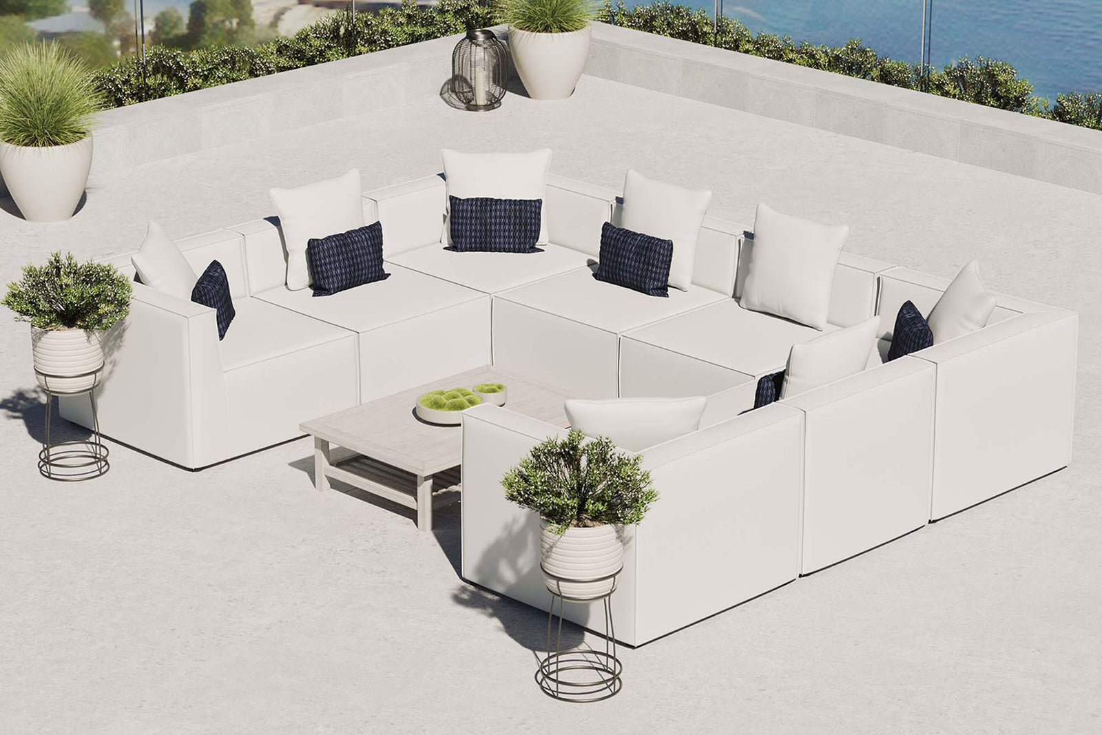 White Saybrook 8-piece outdoor sectional arranged on a sunny terrace with coordinating accent tables. || EEI-4388-WHI || front_angle_room