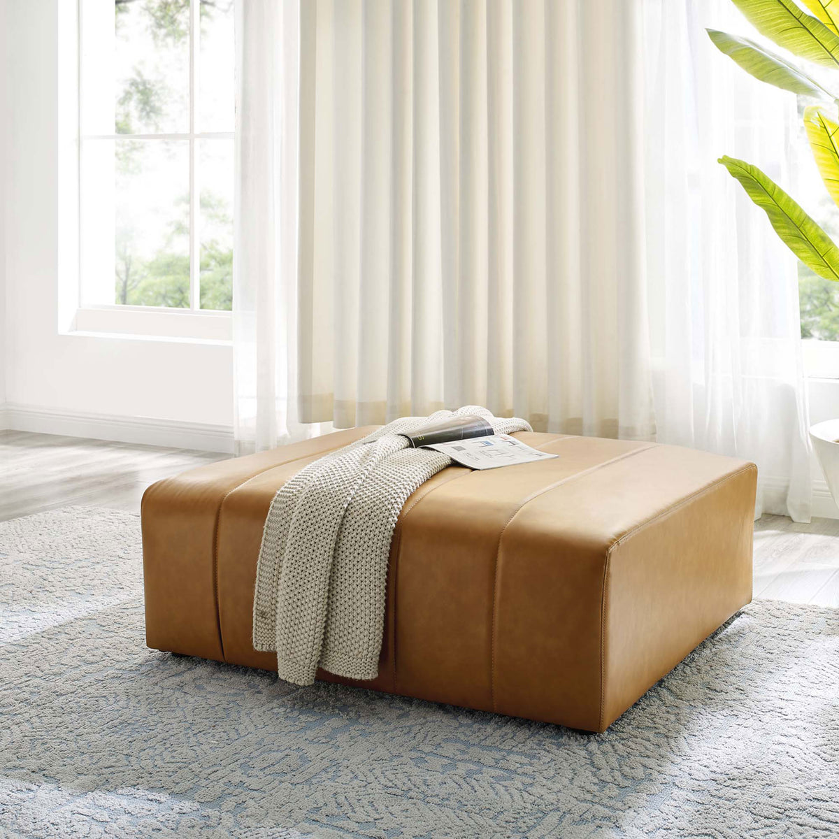 Tan vegan leather ottoman anchors a bright living room, styled with a cozy knit throw and room to rest books or trays || EEI-4401-TAN || front_angle_room