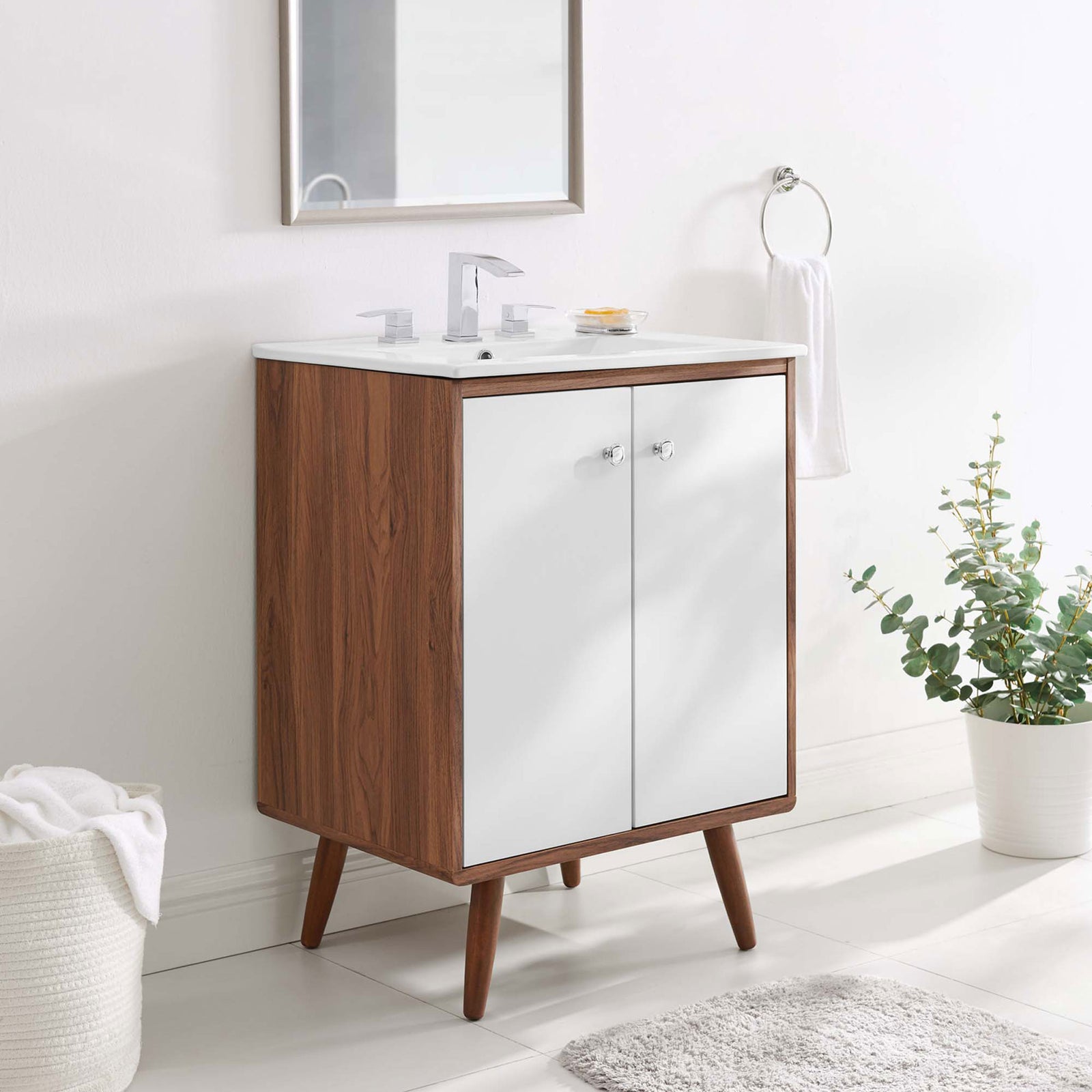 Styled in a bright bath, the 24-inch vanity brings warm walnut contrast to white finishes. || EEI-4432-WAL-WHI || front_angle_room