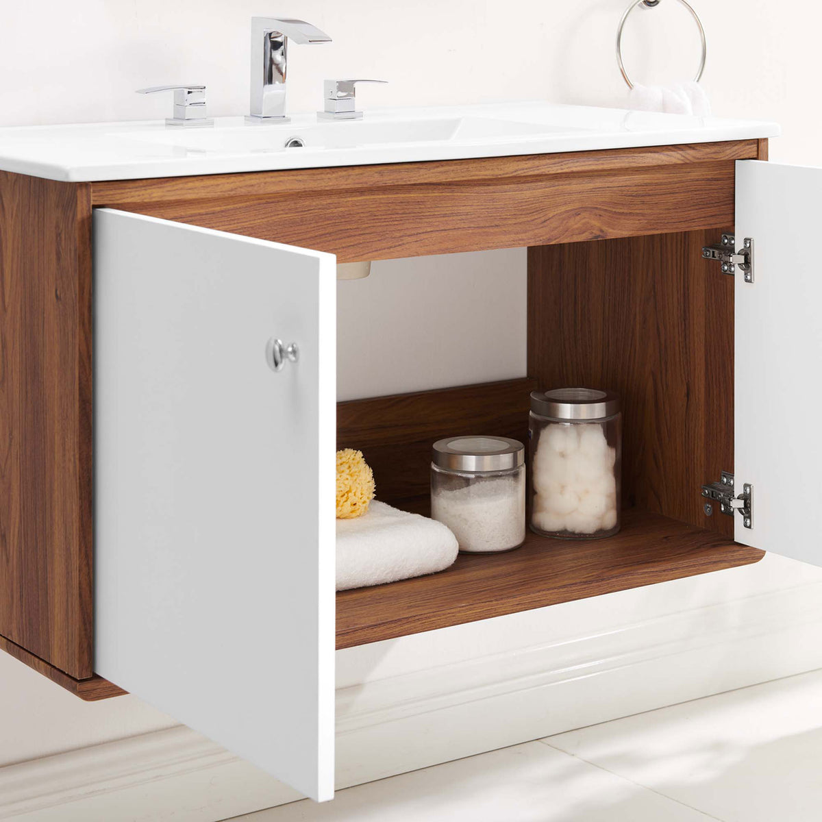 Roomy shelf space behind soft-close doors stores towels, jars, and bath essentials. || EEI-4434-WAL-WHI || storage_open_room