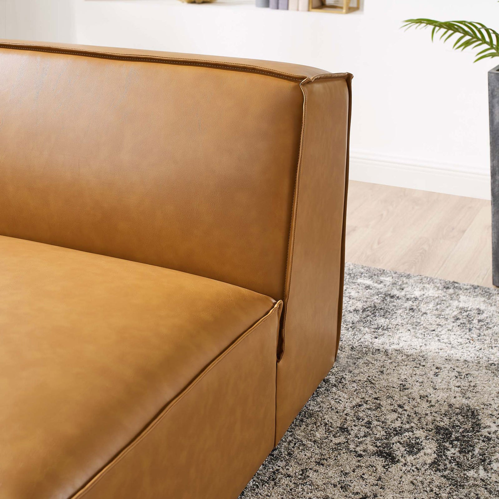 Precision-stitched piping and smooth vegan leather complement the chair's plush, supportive cushioning. || EEI-4495-TAN || detail_room