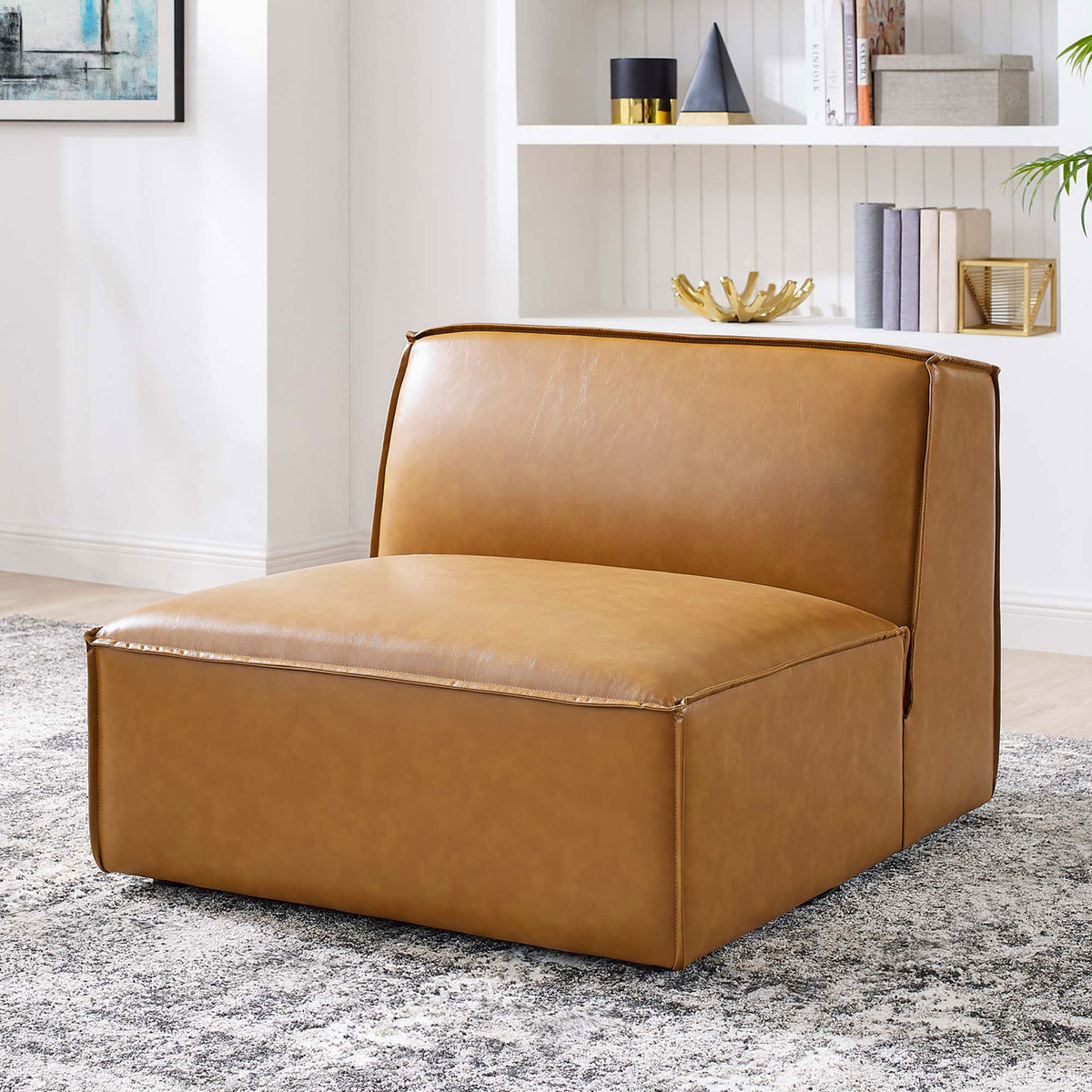 Versatile armless chair elevates living spaces with tan vegan leather and inviting, lounge-ready comfort. || EEI-4495-TAN || front_angle_room