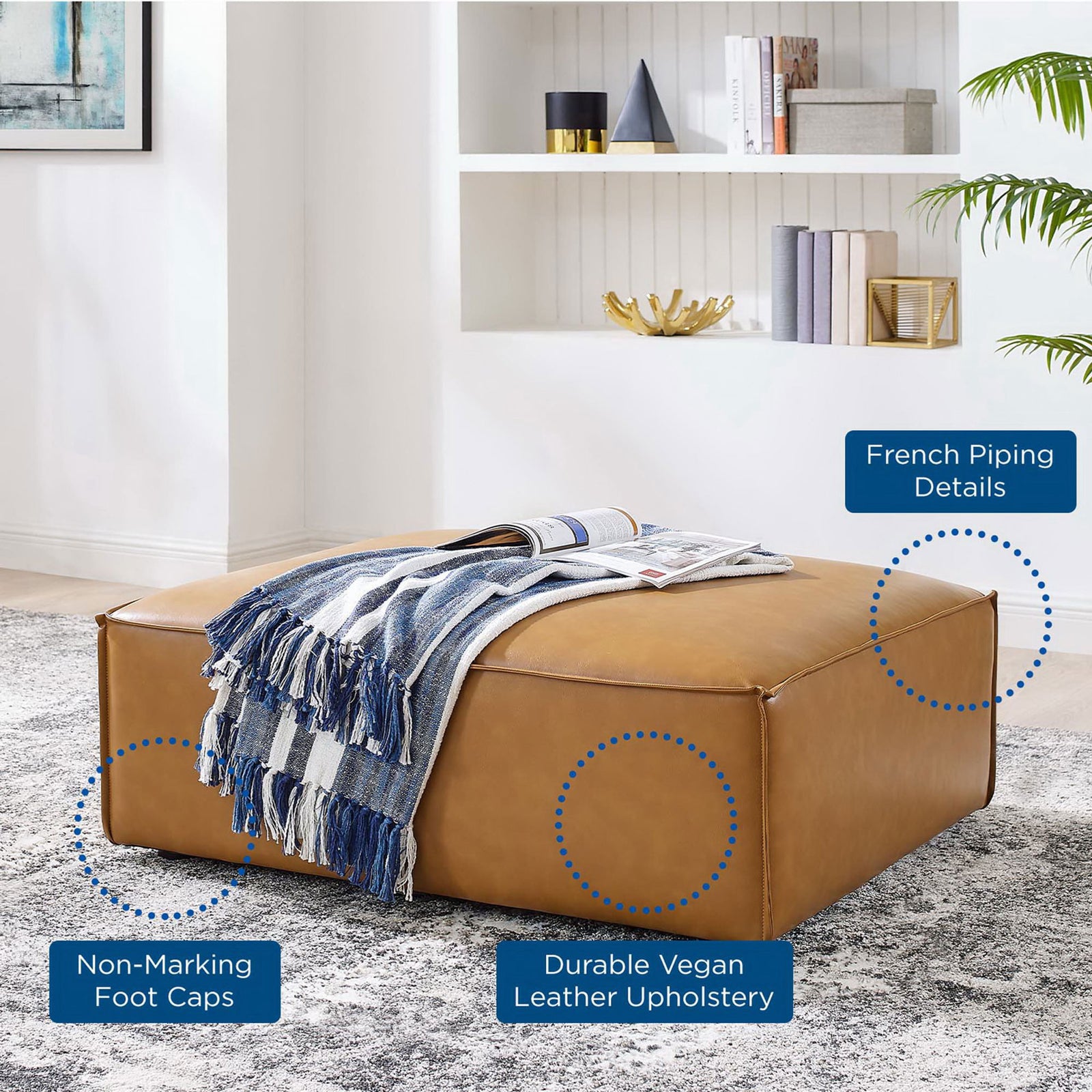 Feature callouts for French piping, durable vegan leather, and non-marking foot caps on tan ottoman || EEI-4496-TAN || callout_room