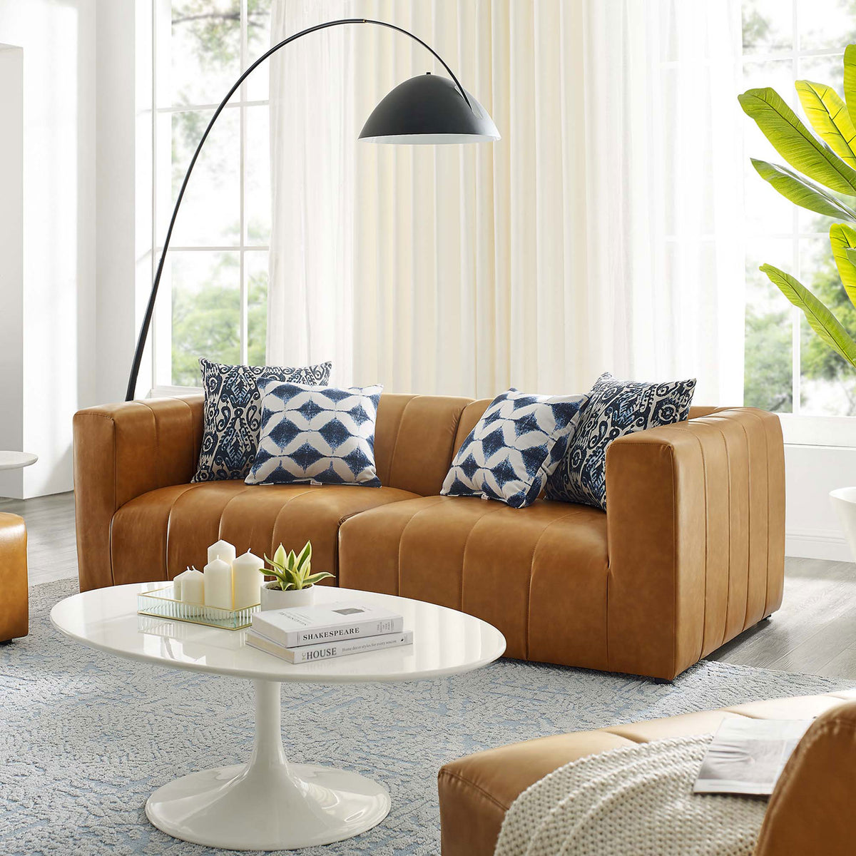 Tan vegan leather loveseat in a modern living room paired with a white tulip coffee table and floor lamp || EEI-4513-TAN || front_angle_room