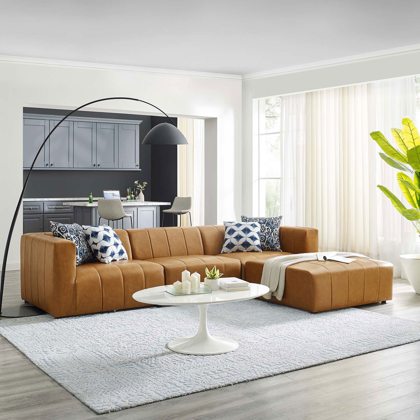 Bartlett tan vegan leather sectional sofa styled in a modern living room with pillows and decor || EEI-4517-TAN || front_angle_room