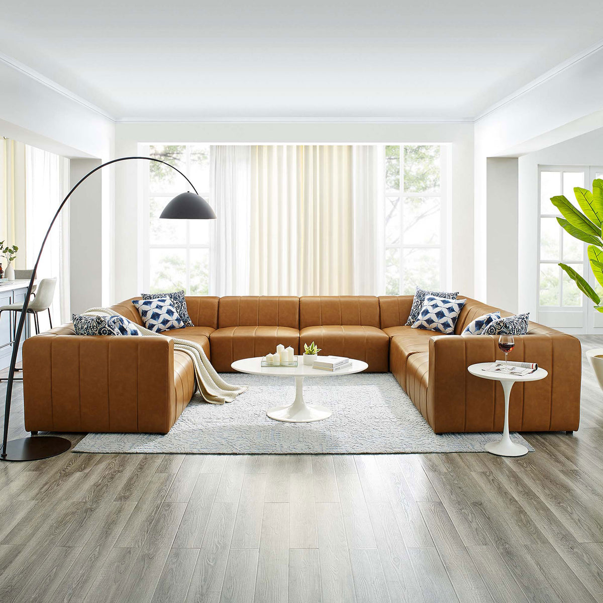 Tan Bartlett 8-piece vegan leather sectional sofa styled in a modern open living room || EEI-4536-TAN || front_angle_room