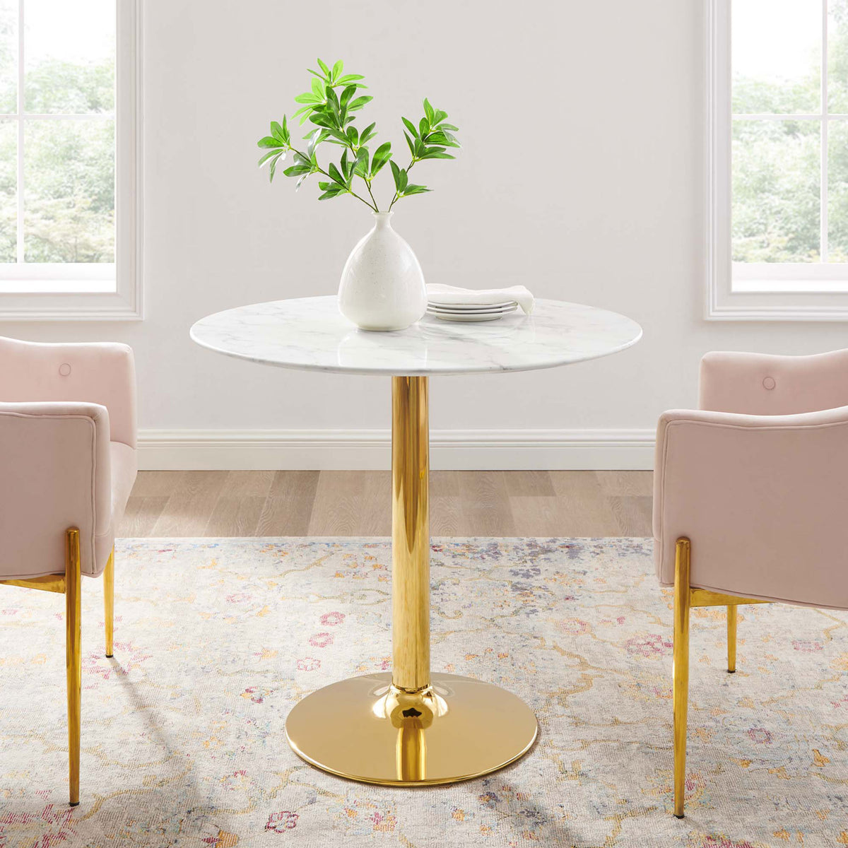 Round marble-look pedestal table styled in a bright dining nook with blush chairs || EEI-4549-GLD-WHI || front_room