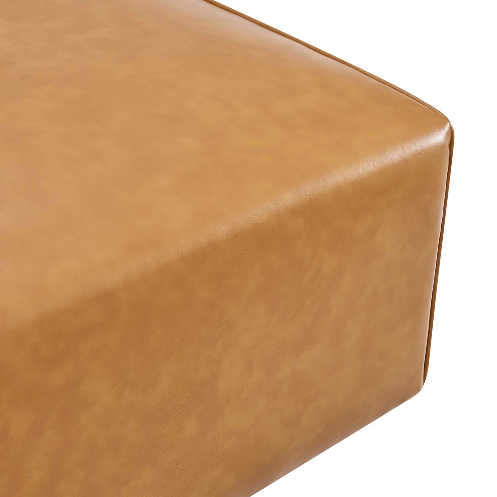 Close-up of smooth tan vegan leather upholstery with refined trim piping on the Mingle ottoman || EEI-4624-TAN || detail_studio