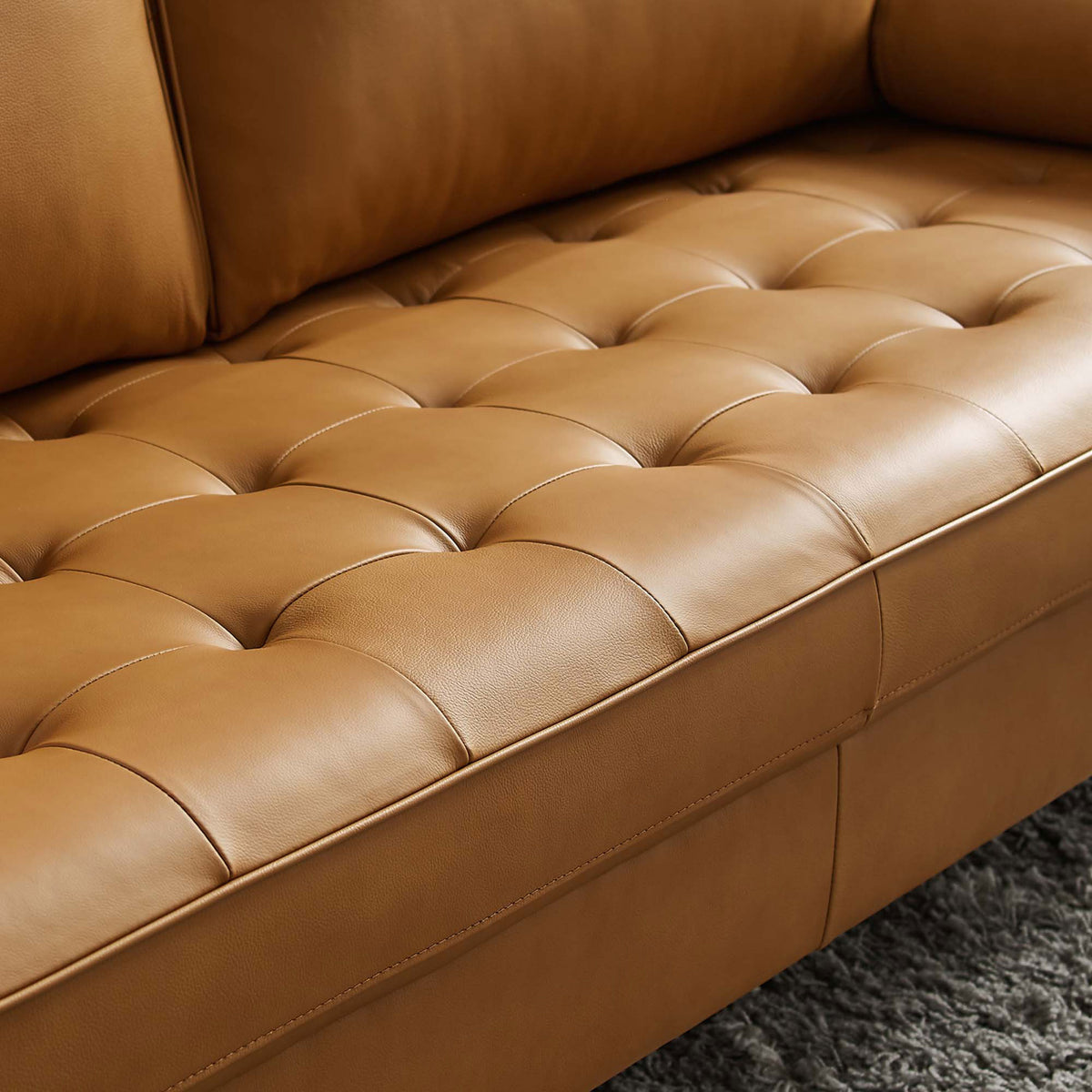 Biscuit-tufted tan leather seat showcasing rich texture and plush cushioning || EEI-4633-TAN || swatch_room