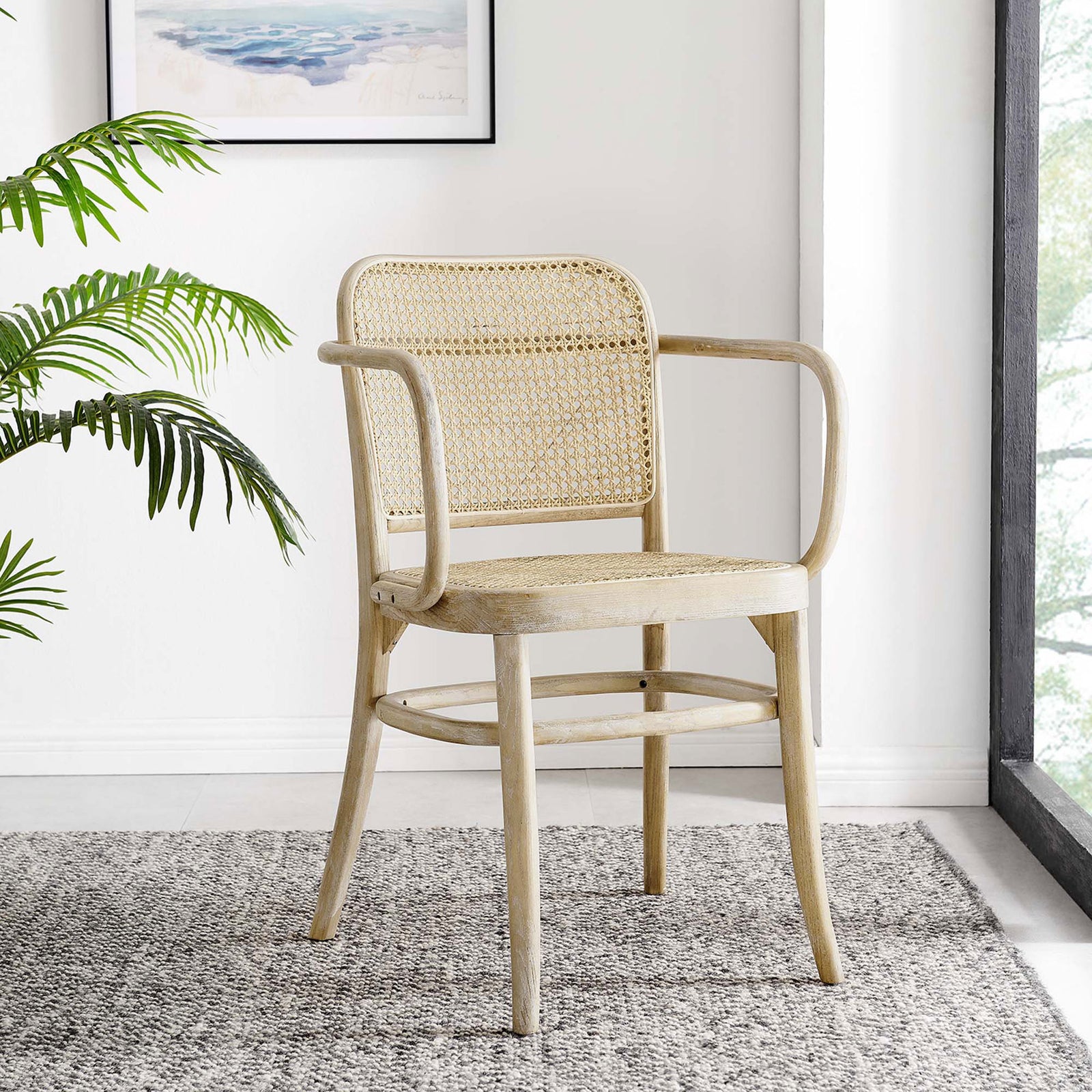 Winona cane dining chair in a bright dining nook beside a window and framed wall art || EEI-4651-GRY || front_angle_room