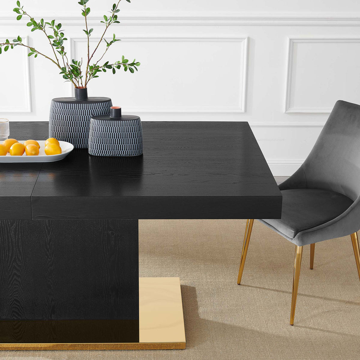 Styled tabletop vignette with black wood dining table, gold base, vases, and gray chair in bright dining room || EEI-4660-BLK-GLD || detail_room