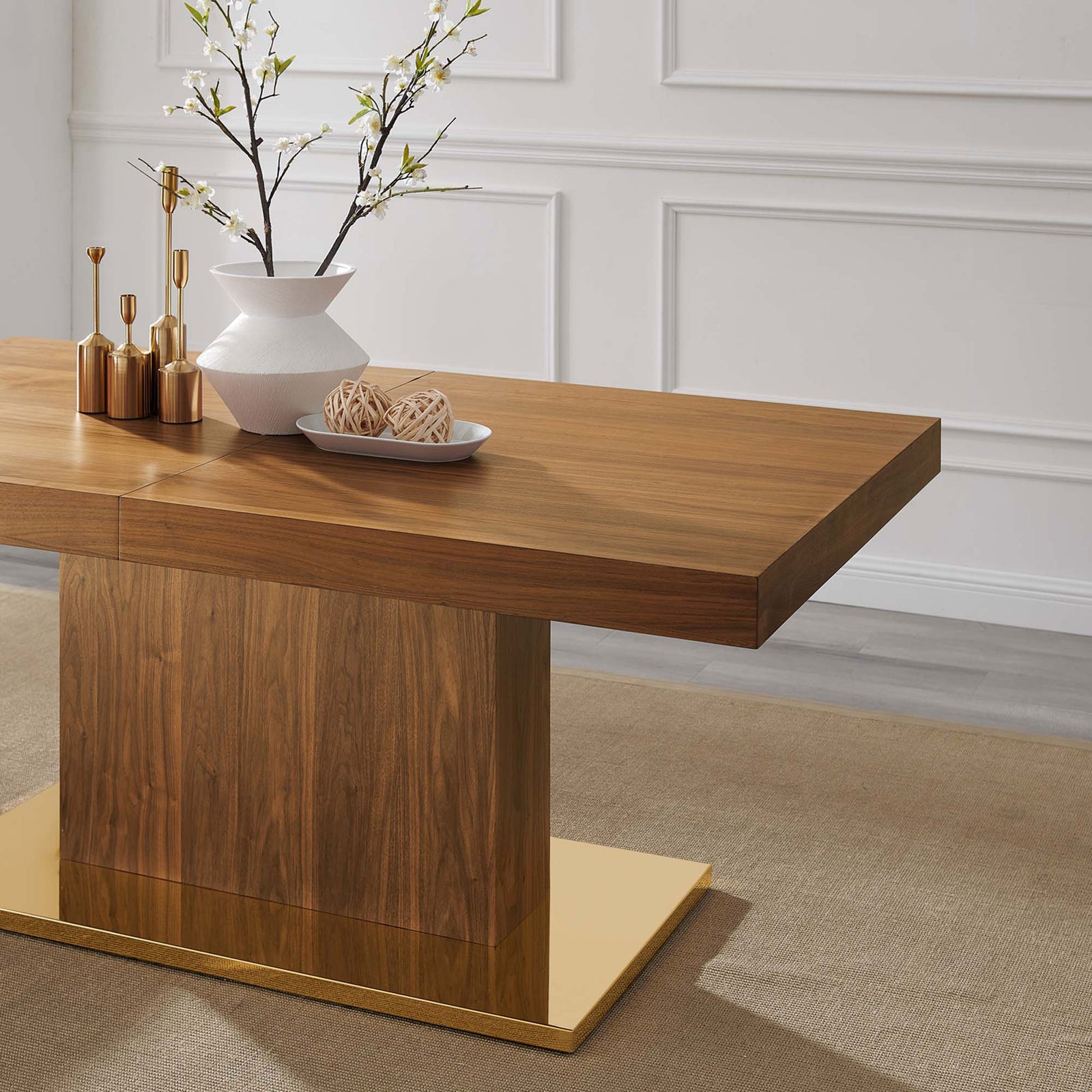 Walnut dining table styled with modern decor accents on a gold pedestal base || EEI-4660-WAL-GLD || detail_room