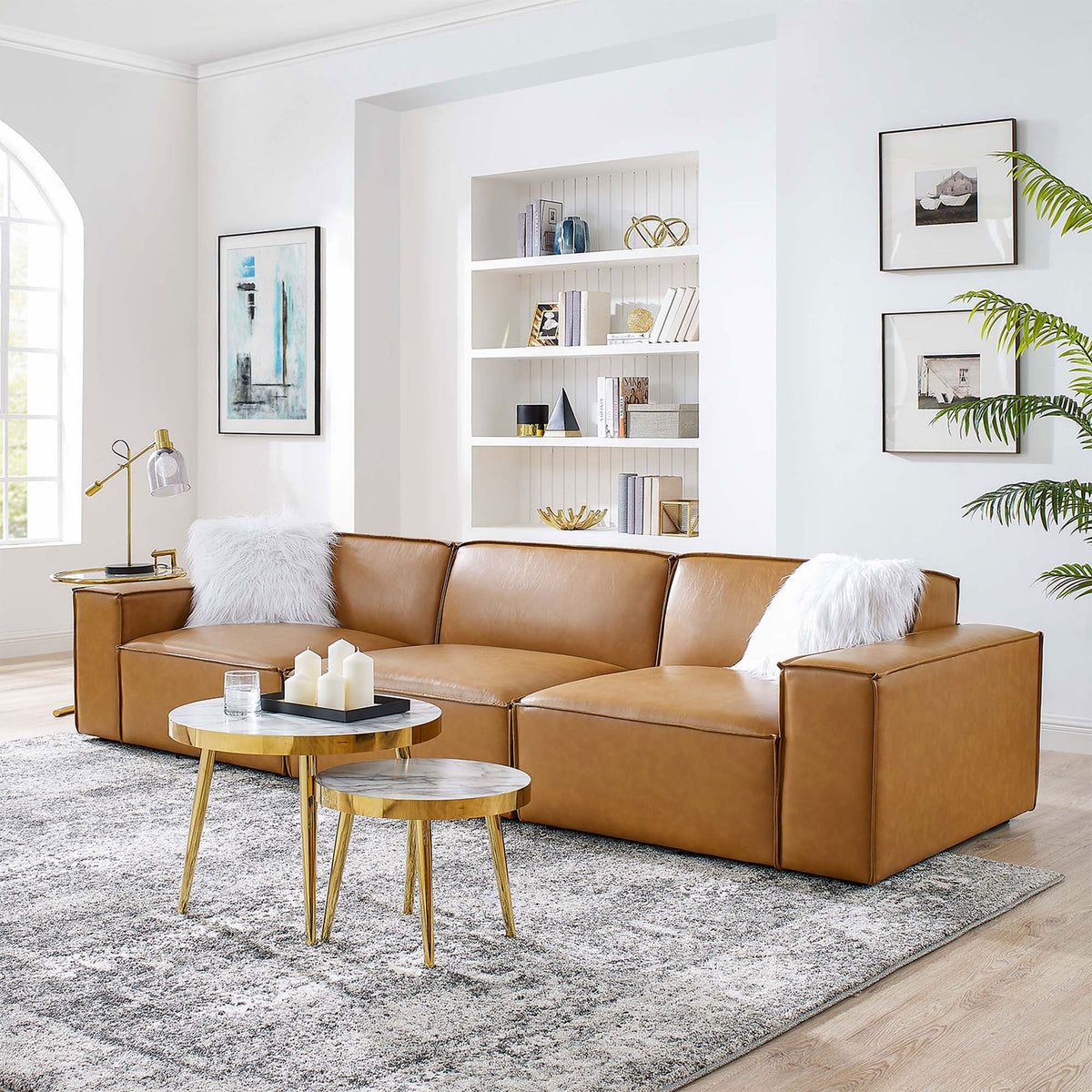 Tan vegan leather modular sofa styled with white pillows, gold tables, and a soft gray area rug || EEI-4708-TAN || front_angle_room