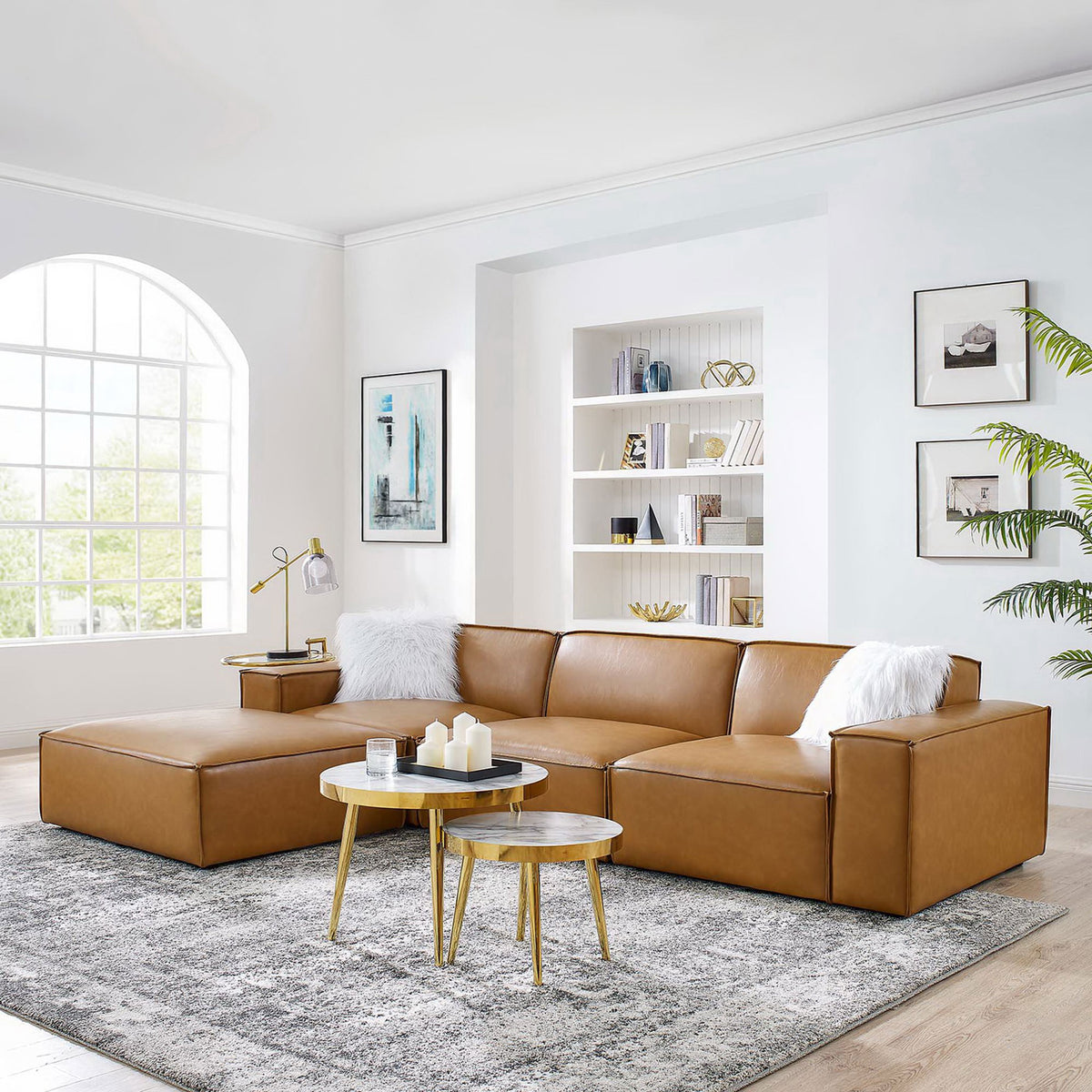 Tan vegan leather sectional anchors a bright modern living room with layered tables and cozy accents || EEI-4709-TAN || front_angle_room