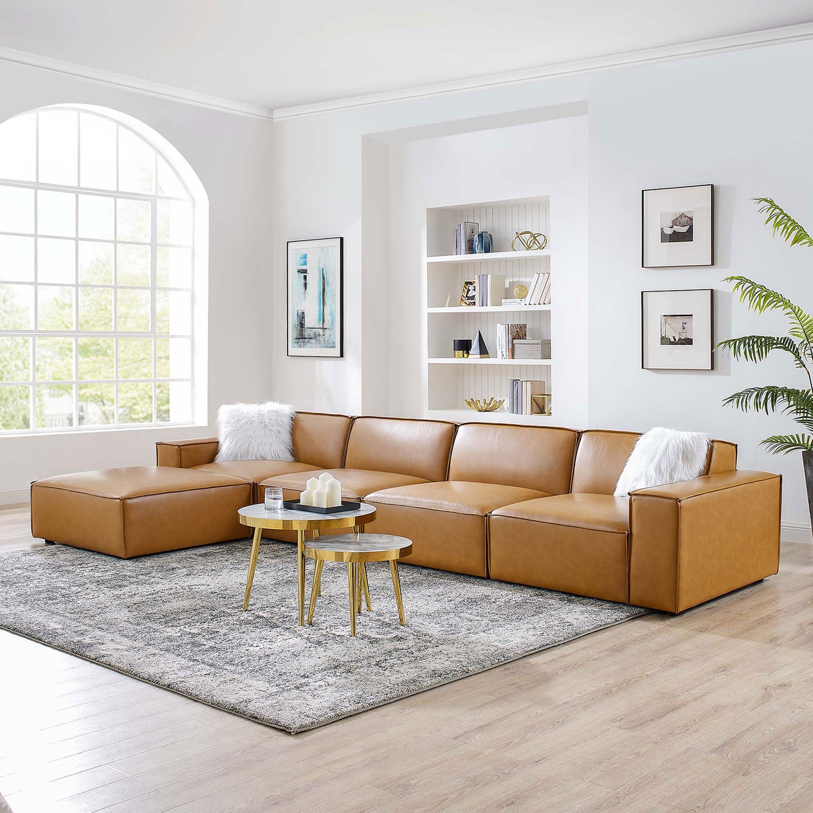 Tan vegan leather Restore sectional styled in a bright living room with rug, pillows, and modern decor || EEI-4711-TAN || front_angle_room