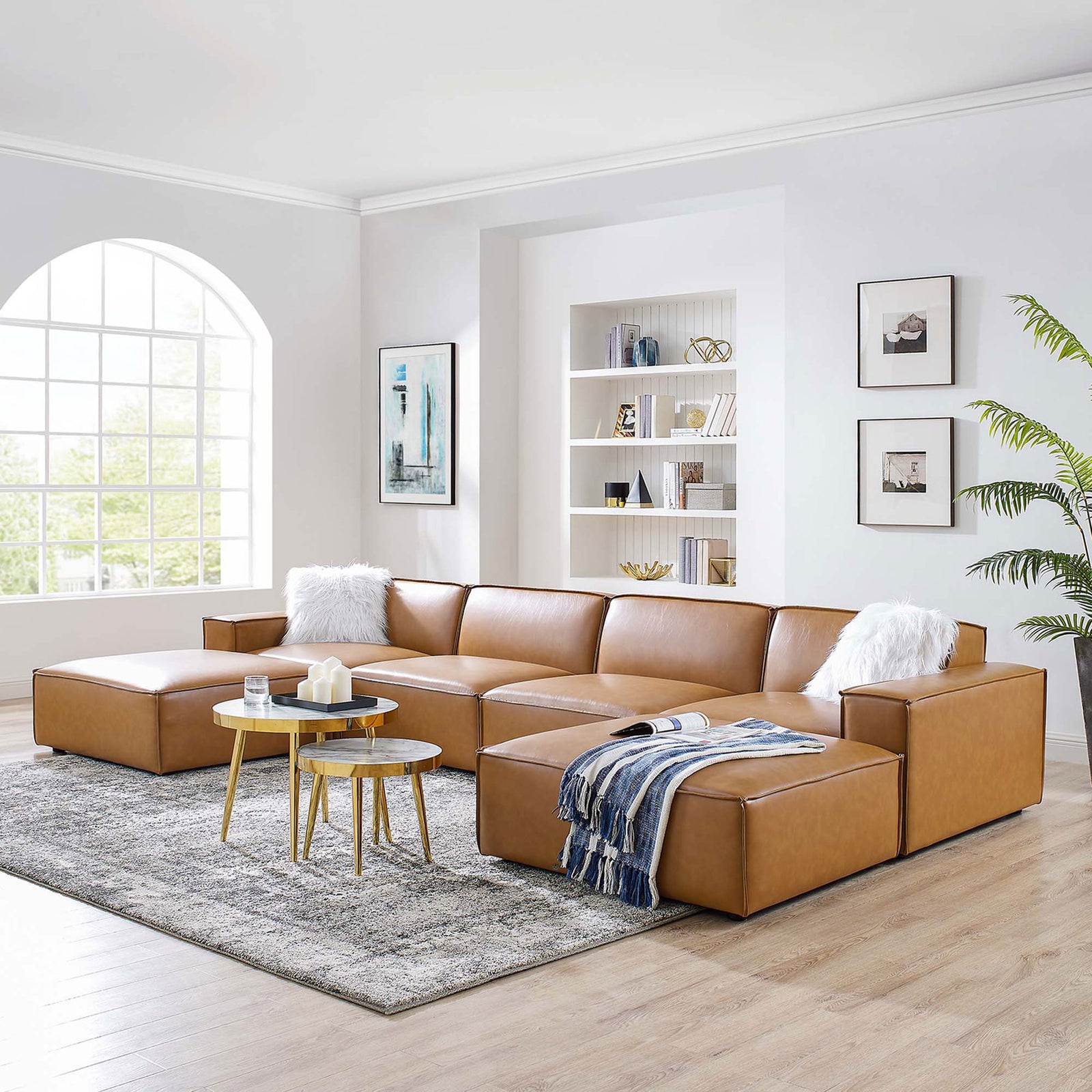 Spacious tan vegan leather 6-piece sectional anchored on a rug in an airy, light-filled living room || EEI-4713-TAN || front_angle_room