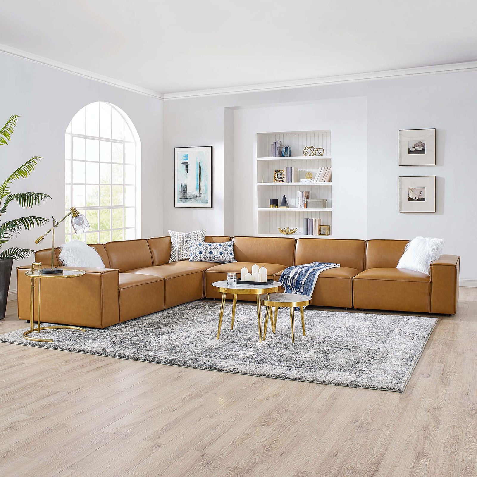 Spacious tan vegan leather sectional arranged in a bright living room with modern accent tables || EEI-4715-TAN || front_angle_room
