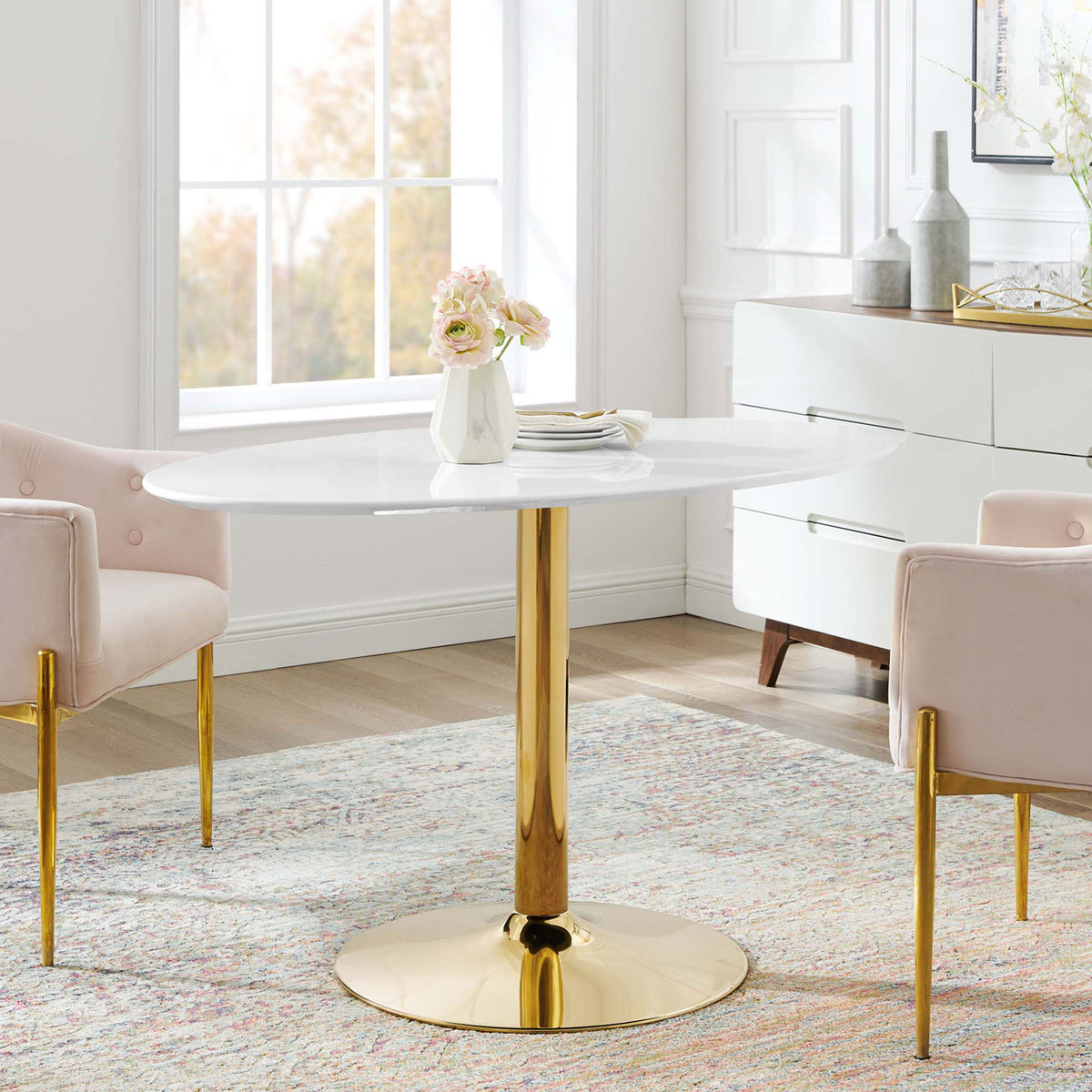 Verne 48-inch oval dining table with blush chairs creating a sophisticated modern dining area || EEI-4750-GLD-WHI || front_room