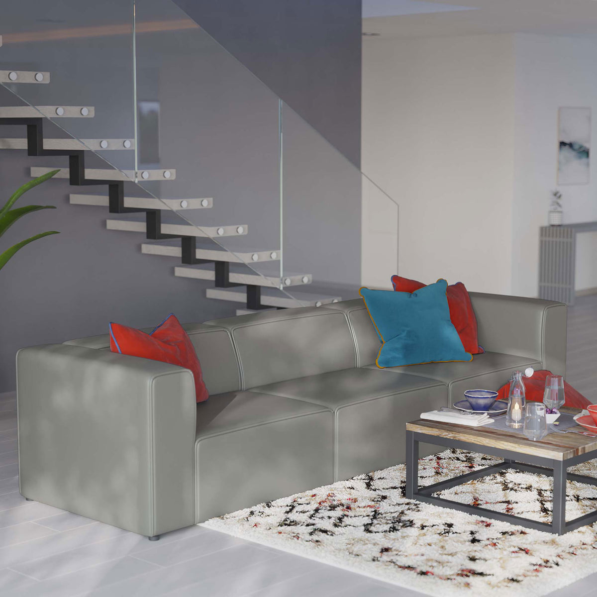Gray vegan leather sectional styled with colorful pillows in a bright open-concept living space || EEI-4789-GRY || front_angle_room