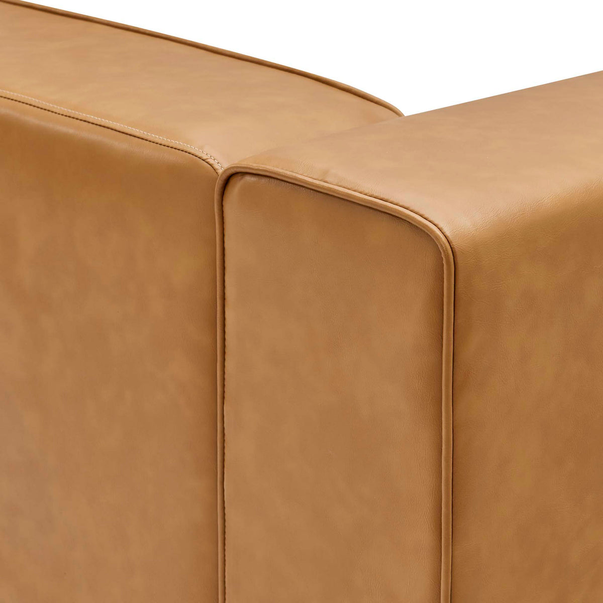 Detail of tan vegan leather upholstery and neat stitching along the modular sofa corner || EEI-4794-TAN || detail_studio