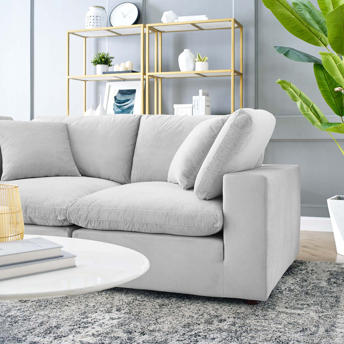 Plush light gray velvet cushions pair with a broad, squared arm for cozy comfort