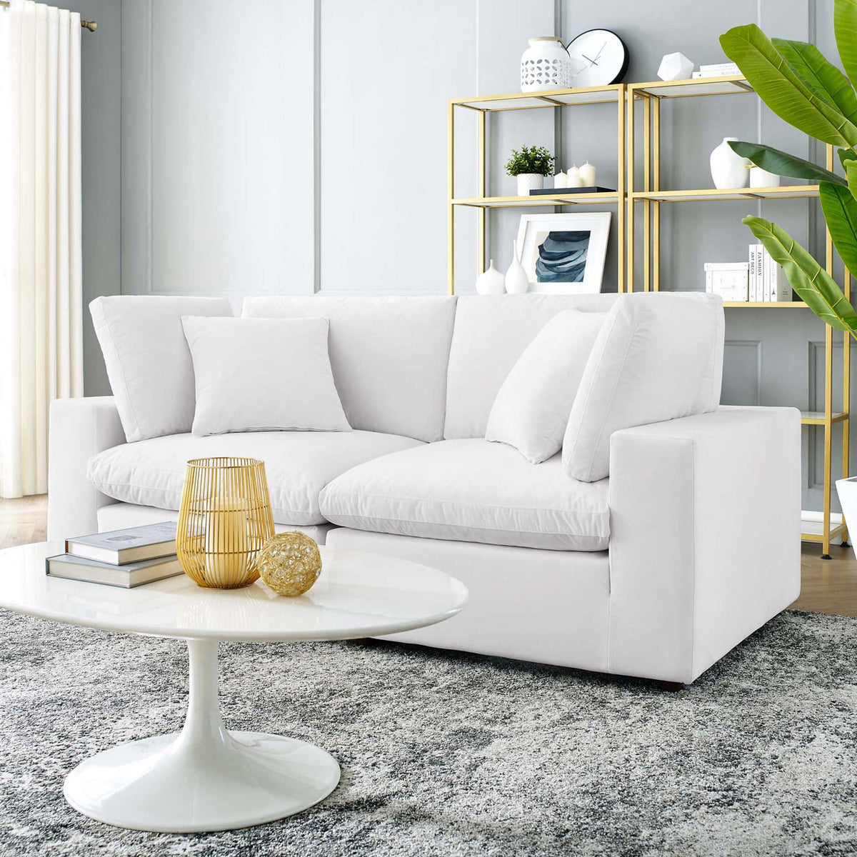 A plush white velvet loveseat adds airy softness and generous seating to the living room