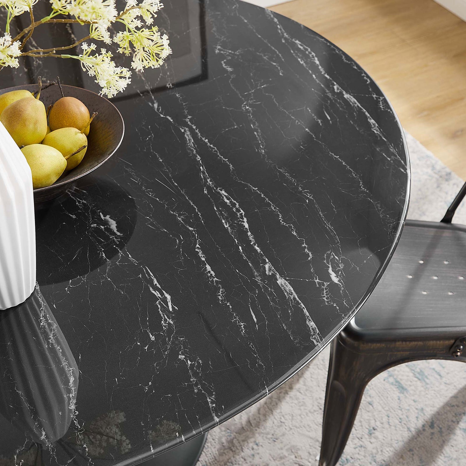 Tabletop detail of 54 inch faux marble surface styled with fruit bowl and decorative vase. || EEI-4878-BLK-BLK || detail_room