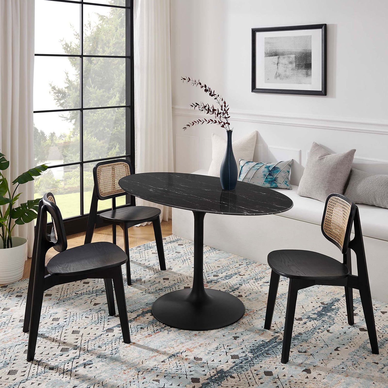 Black oval pedestal dining table styled with black chairs in a bright modern breakfast nook || EEI-4880-BLK-BLK || front_angle_room