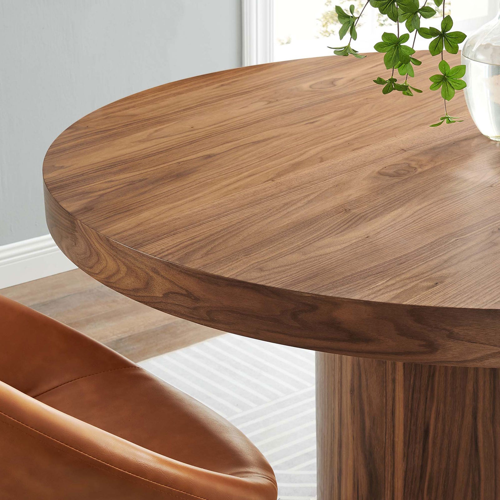 Warm walnut tabletop pairs with soft upholstered chairs for welcoming everyday meals || EEI-4911-WAL || detail_room