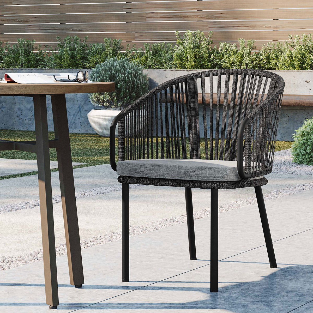 Harbor charcoal rope armchair on a modern patio for relaxed outdoor dining and lounging || EEI-5033-CHA-GRY || front_angle_room