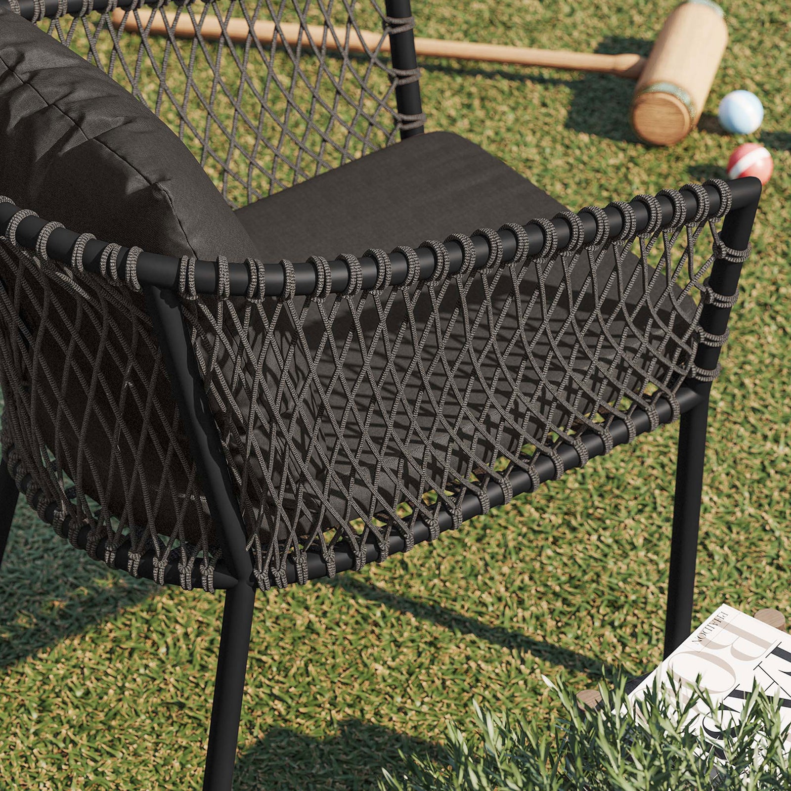 Woven rope arm and cushion of the charcoal outdoor dining armchair styled on a green lawn || EEI-5040-CHA-CHA || detail_room