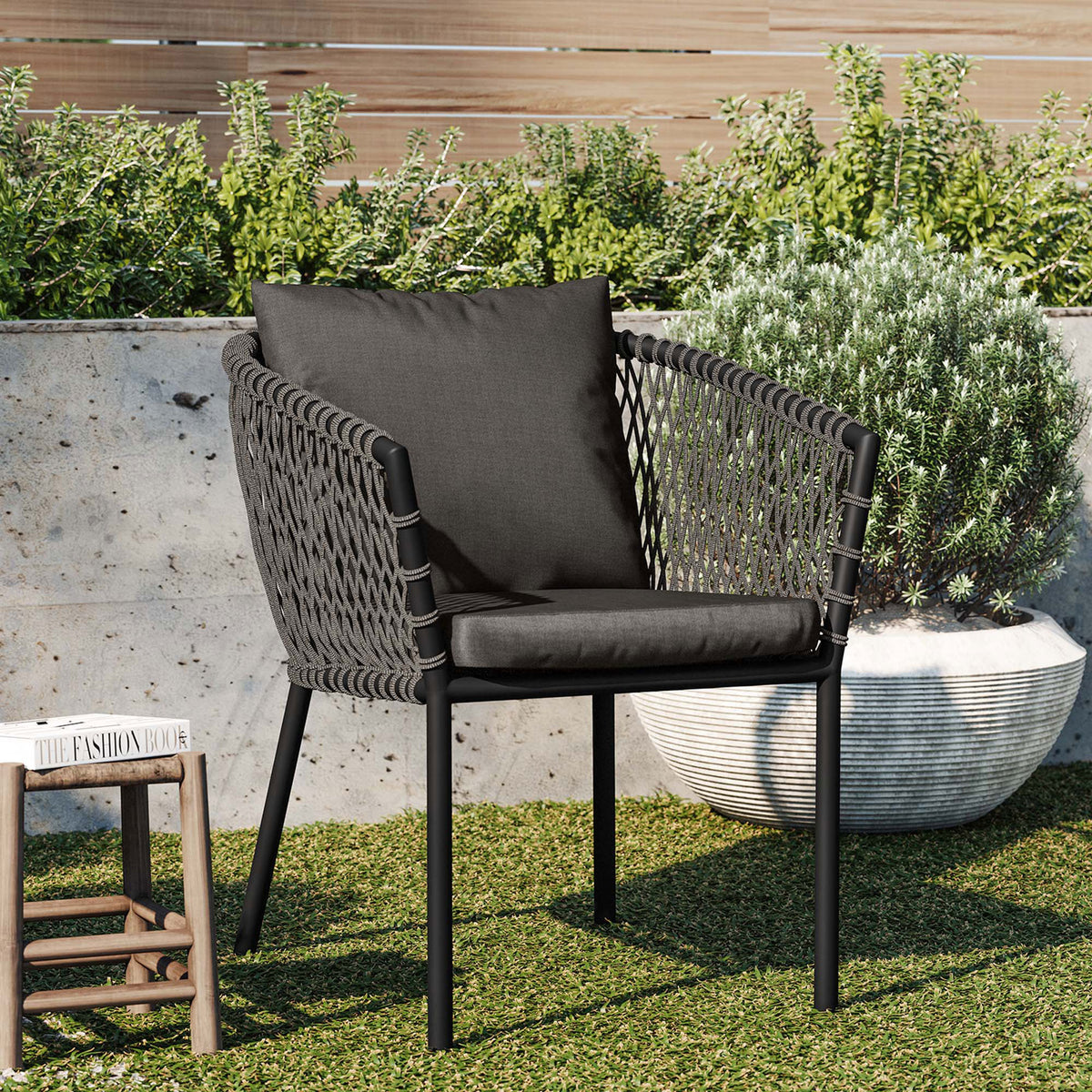 Charcoal outdoor dining armchair with rope sides and cushions styled in a modern garden setting || EEI-5040-CHA-CHA || front_angle_room