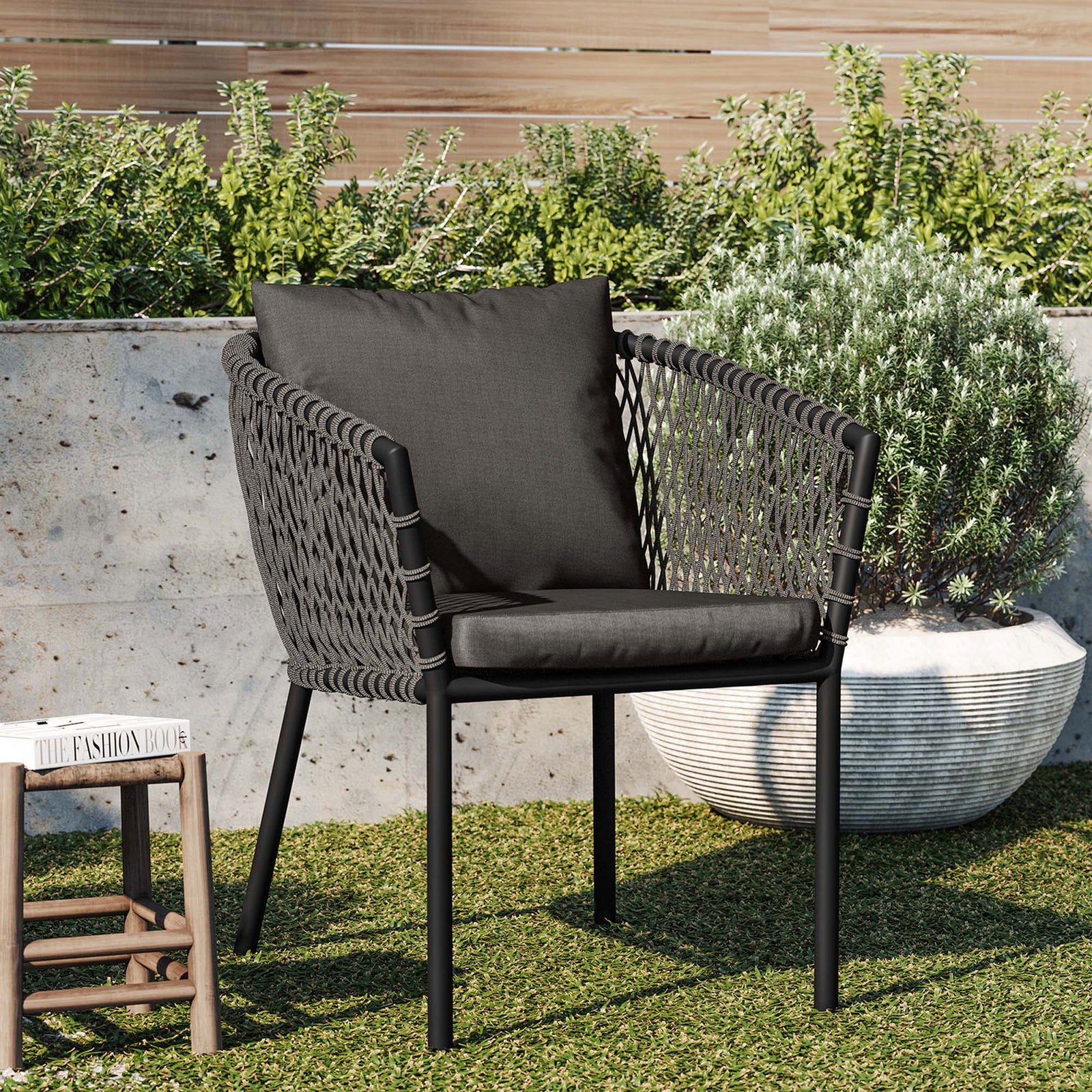 Charcoal outdoor dining armchair with rope sides and cushions styled in a modern garden setting || EEI-5040-CHA-CHA || front_angle_room