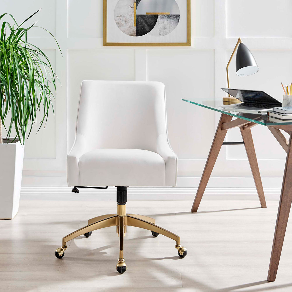 White velvet office chair with gold base placed at a contemporary workspace with plant and wall art || EEI-5079-WHI || front_room