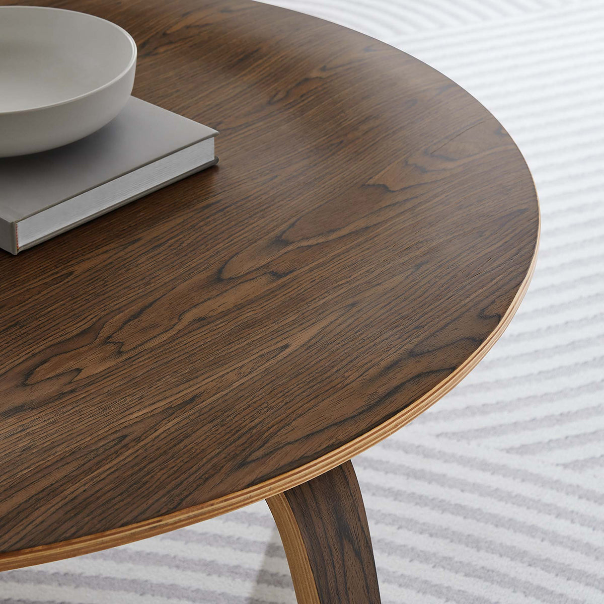 Detailed wood grain and a slender layered edge add natural texture to the round tabletop