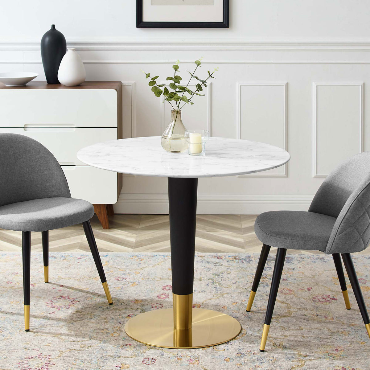 36 inch round faux marble dining table anchoring a modern dining space with gray upholstered chairs || EEI-5122-GLD-WHI || front_room