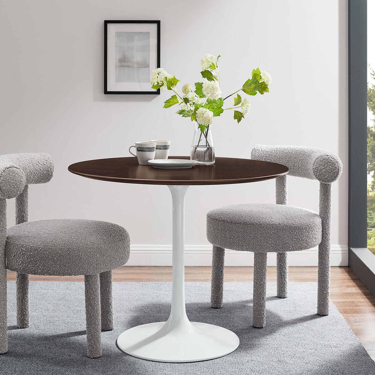 Round pedestal dining table with gray upholstered chairs in a bright modern dining nook || EEI-5157-WHI-CHE || front_angle_room