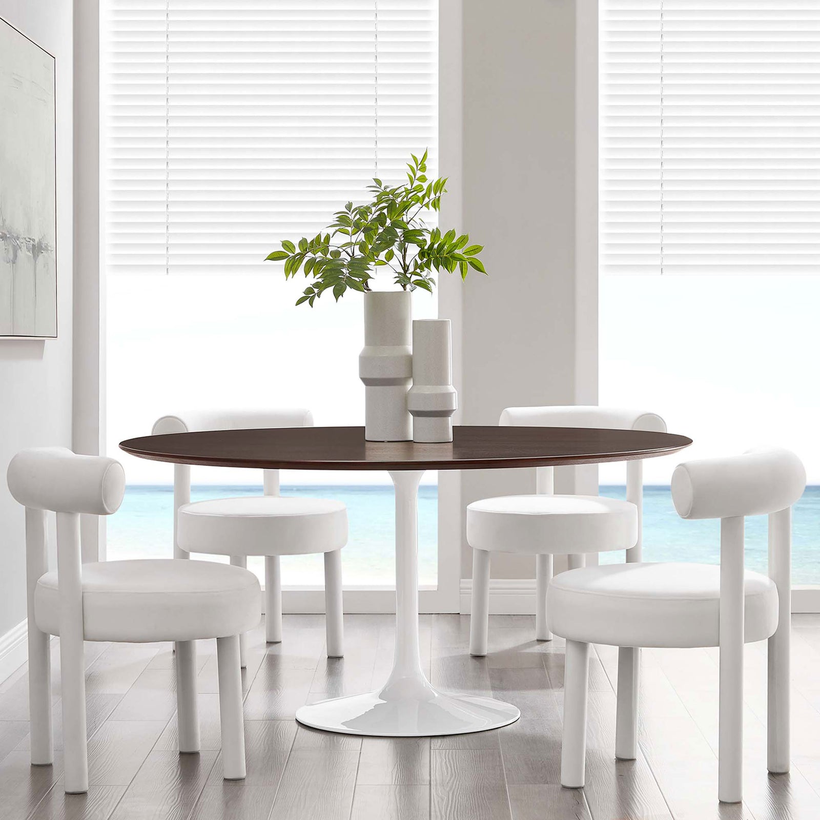 Generous round pedestal dining table with four chairs in a bright coastal dining room || EEI-5175-WHI-CHE || front_angle_room