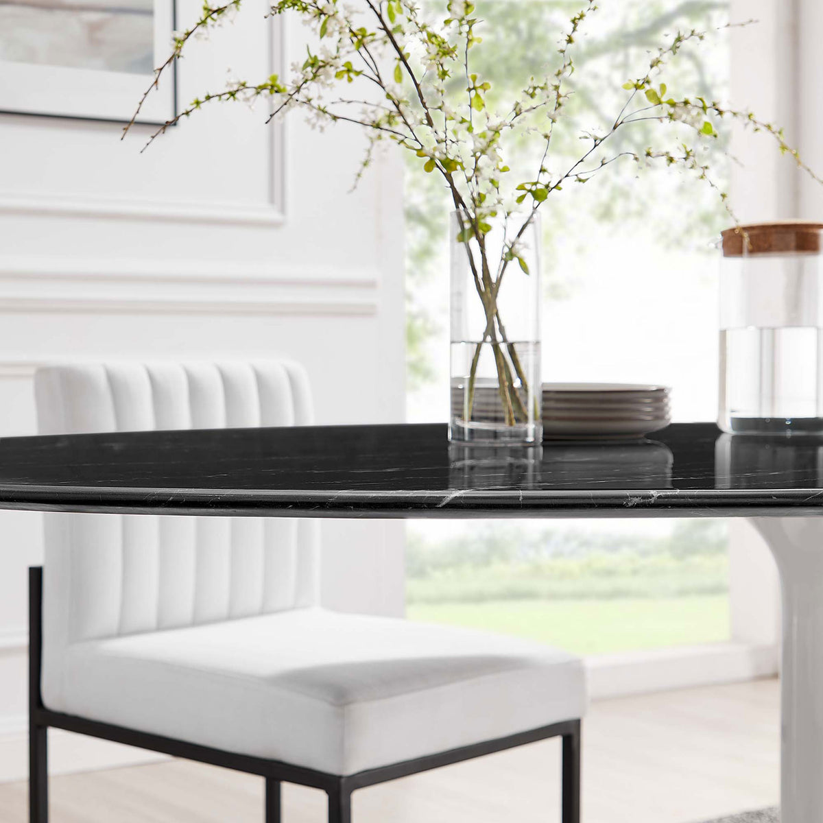 Black faux marble tabletop of the Lippa 78 in. dining table styled with white chair and slim glass vase || EEI-5198-WHI-BLK || detail_room