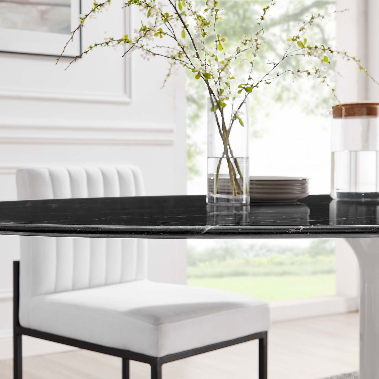 Black faux marble tabletop of the Lippa 78 in. dining table styled with white chair and slim glass vase || EEI-5198-WHI-BLK || detail_room